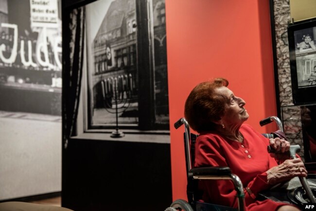 Holocaust survivor Veronica Phillips looks at her family portraits and memorabilia during the official opening of the Johannesburg Holocaust & Genocide Center and its permanent exhibition in Johannesburg, March 14, 2019.
