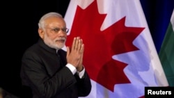 Prime Minister of India Narendra Modi speaks to a crowd during a dinner hosted by his Canadian counterpart Stephen Harper in Vancouver, British Columbia, April 16, 2015.