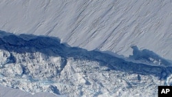 A massive crack running about 29 kilometers across Pine Island glacier’s floating tongue, taken during flight over region late October 2011.