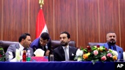 FILE - Iraqi Parliament Speaker Mohammed al-Halbousi, center, meets with Basra provincial Council members in Basra, 340 miles (550 km) southeast of Baghdad, Iraq, Sept. 18, 2018. 