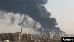 Smoke rises from a Syrian regime-controlled cement factory, in Aleppo, Syria, Aug. 9, 2016. Russia announced a cease-fire to permit humanitarian aid into the city Wednesday. 