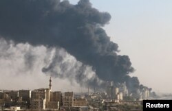 A general view shows rising smoke from a Syrian regime-controlled cement factory, in Aleppo, Syria, Aug. 9, 2016.