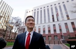 Hawaii Attorney General Doug Chin speaks with reporters in front of a federal courthouse after appearing there Dec. 6, 2017, in Seattle. Judges of the 9th U.S. Circuit heard arguments in Hawaii's challenge to President Donald Trump's latest travel ban, which restricts travel to the United States by residents of eight nations and has been reviled by critics as discriminatory.