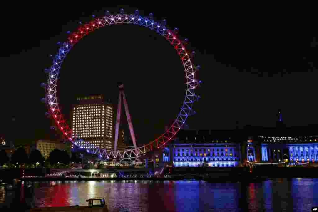 The London Eye on the banks of the Thames is lit up in red, blue and white to mark the birth of a baby boy to Prince William and Kate, Duchess of Cambridge, London, July 22, 2013.