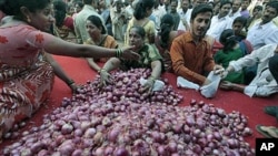 People try to grab onions being sold by a political party at cheap rates as a mark of protest against the rising prices in Mumbai, India, January 9, 2011 (file photo)