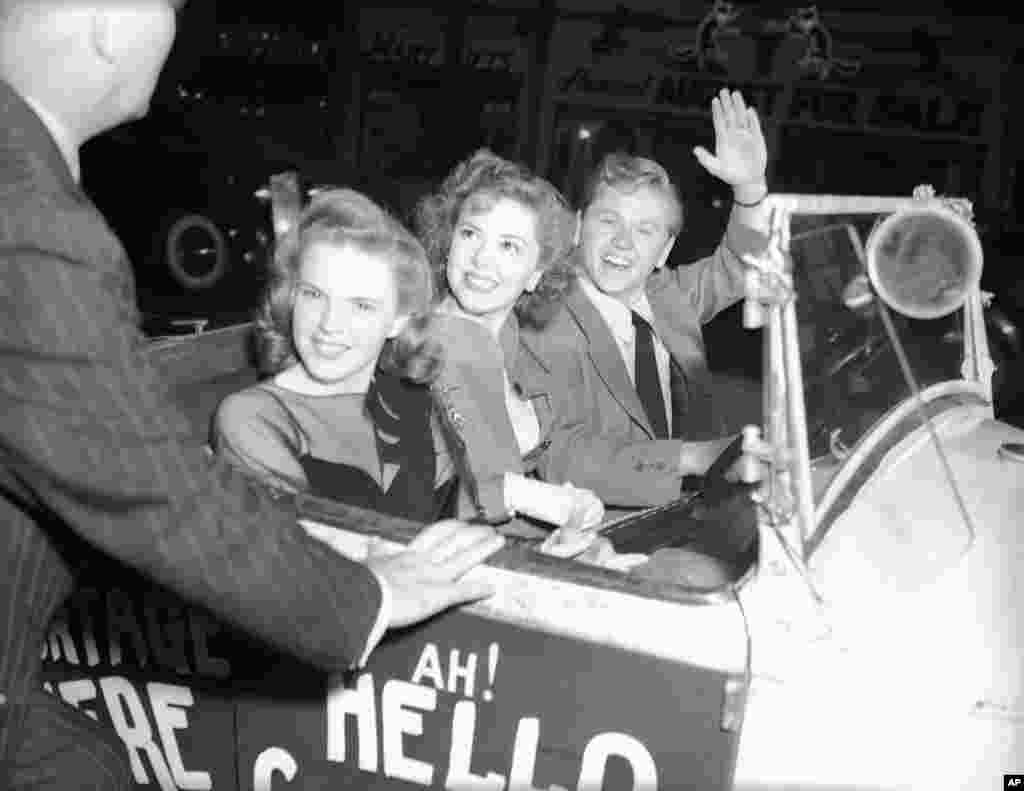 Mickey Rooney, accompanied by Judy Garland and Ann Rutherford, arriving at the theater in an old Jalopy, New York City, August 17, 1941.