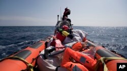 Proactiva Open Arms crew conduct a search-and-rescue operation in the Mediterranean Sea, 12 nautic miles from the Libyan coast, April 13, 2017.