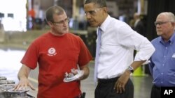 President Barack Obama talks with employees Mike Clements, right, and Richard Thomas during a tour at Allison Transmission in Indianapolis, Ind., May 6, 2011.