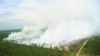 FILE - A wildfire is seen from a Ministry of Environment and Forestry helicopter over Kubu Raya, near Pontianak, West Kalimantan, Indonesia, Aug. 25, 2016.