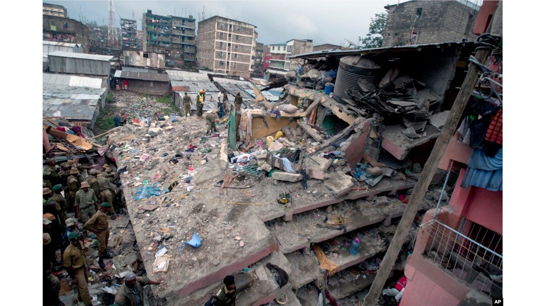 FILE - Kenyan police officers and Kenyan National Youth Servicemen search the site of a building collapse in Nairobi, Kenya, April 30, 2016.