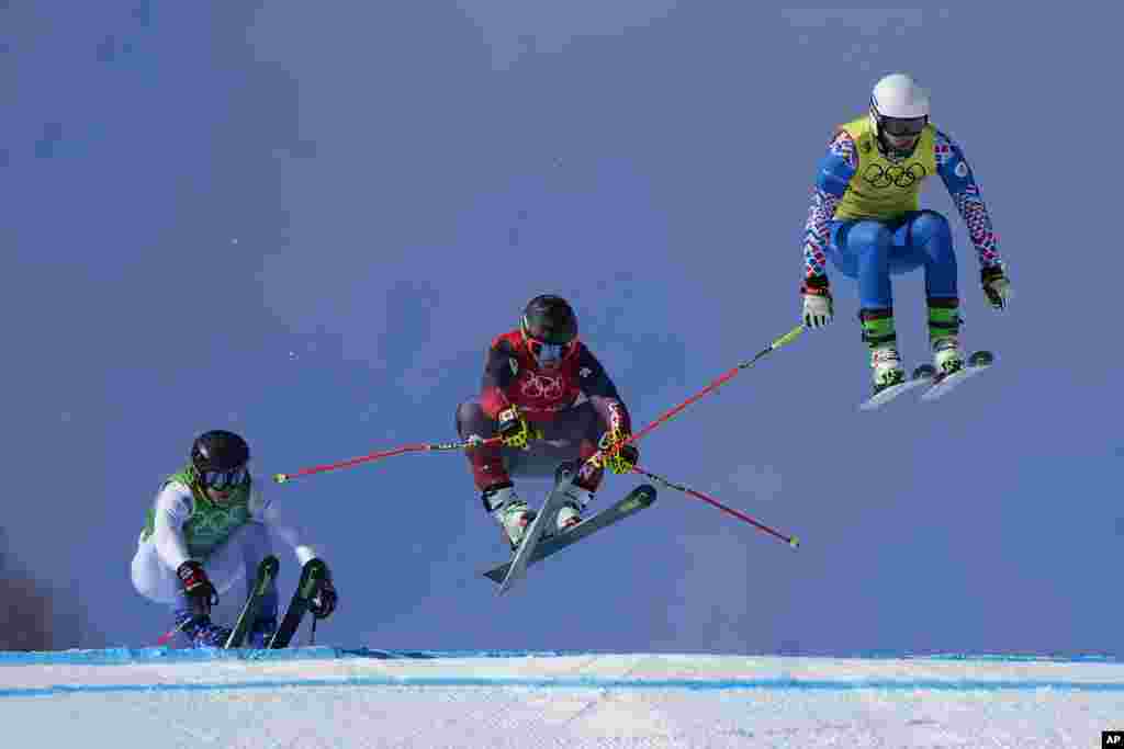 Sergey Ridzik of the Russian Olympic Committee leads the pack, followed by Canada&#39;s Brady Leman and Sweden&#39;s David Mobaerg, during the men&#39;s cross finals at the 2022 Winter Olympics, in Zhangjiakou, China.