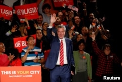 New York Mayor Bill de Blasio is greeted by supporters after his re-election in New York City, Nov. 7, 2017.