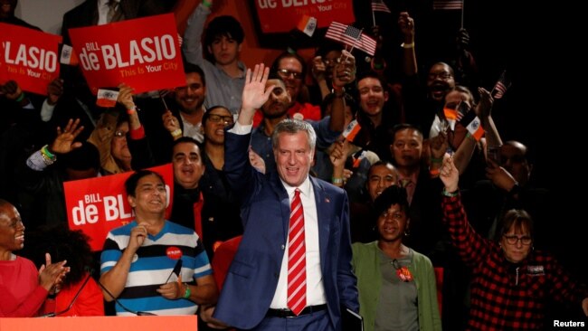 New York Mayor Bill de Blasio is greeted by supporters after his re-election in New York City, Nov. 7, 2017.