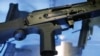 FILE - A little-known device called a "bump stock" is attached to a semi-automatic rifle at the Gun Vault store and shooting range, in South Jordan, Utah, Oct. 4, 2017. The device was used by Las Vegas shooter Stephen Paddock.