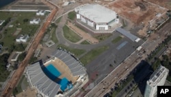 FILE - The Olympic Arena, top, and the Maria Lenk Aquatics Center under construction in Rio de Janeiro, Brazil, June 27, 2014. International sports federations expressed concern Tuesday over problems with venues for the summer Olympics.