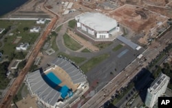 FILE - The Olympic Arena, top, and the Maria Lenk Aquatics Center under construction in Rio de Janeiro, Brazil, June 27, 2014. International sports federations expressed concern Tuesday over problems with venues for the summer Olympics.