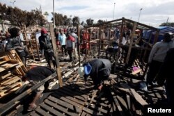African migrants build a makeshift house after their houses burned, on the outskirts of Casablanca, Morocco, Oct. 29, 2018.