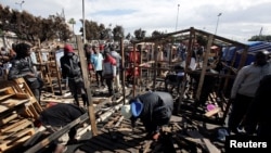 African migrants build a makeshift house after their houses burned, on the outskirts of Casablanca, Morocco, Oct. 29, 2018. 