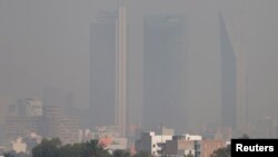 Buildings are pictured shrouded in smog in Mexico City, Mexico, May 3, 2016.