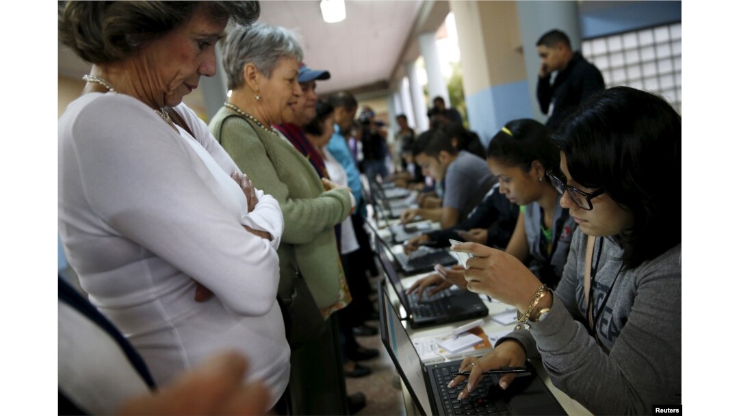 People register to cast their vote at a polling station during a legislative election, in Caracas, Venezuela, Dec. 6, 2015.