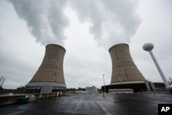 File - A May 22, 2017, photo shows cooling towers at the Three Mile Island nuclear power plant in Middletown, Pennsylvania.