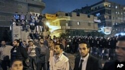 Hundreds of opposition Muslim Brotherhood supporters alleging electoral fraud make a standoff with riot police outside a counting center in the Shubra el-Kheima neighborhood of Cairo, Egypt, 28 Nov 2010