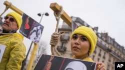 Iranian opposition protesters march during a rally to protest against executions in Paris, France.