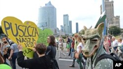 Protesters march with placard reading "The Forest is Ours", demanding a stop to massive logging in the Bialowieza forest, one of Europe's last virgin woodlands, in Warsaw, Poland, June 24, 2017.