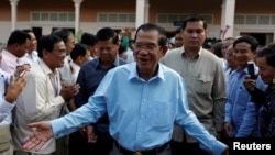 Cambodia's Prime Minister and President of the Cambodian People's Party (CPP), Hun Sen is surrounded by his commune counselors during a Senate election in Takhmao, Kandal province, Cambodia February 25, 2018. 