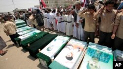 Yemeni people attend the funeral of victims of a Saudi-led airstrike, in Saada, Yemen, Aug. 13, 2018. 