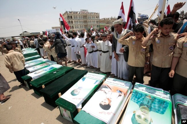 Yemeni people attend the funeral of victims of a Saudi-led airstrike, in Saada, Yemen, Aug. 13, 2018.