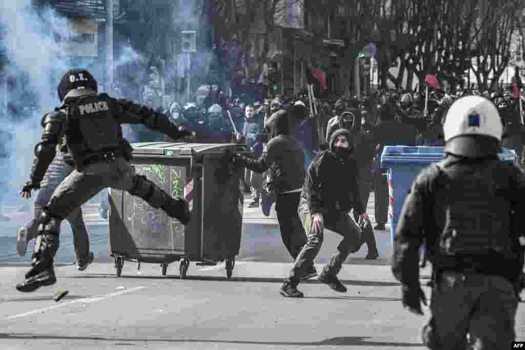 Protesters throw stones at riot police during clashes in Thessaloniki, Greece.&nbsp;Thousands of students take part in a demonstration against the operation of the evacuation of the Aristotle University by police.