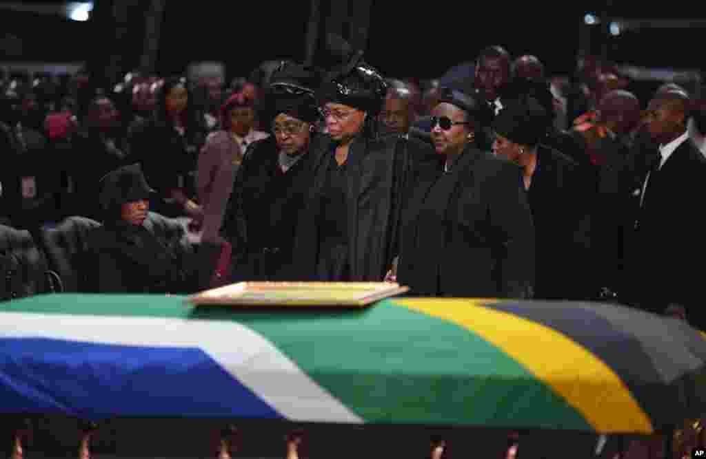 Winnie Madikizela-Mandela, left, Nelson Mandela&#39;s former wife, left and Nelson Mandela&rsquo;s widow Graca Machel stand over the former South African president&#39;s casket during his funeral service in Qunu.