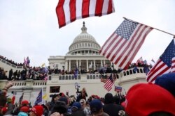 FILE - Supporters of President Donald Trump gather outside the US Capitol in Washington, Jan. 6, 2021.