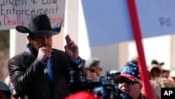 FILE - Otero County Commissioner Couy Griffin speaks to a crowd on Jan. 31, 2020, in Santa Fe, New Mexico.
