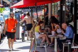 Diners enjoy lunch in outdoor seating at a Little Italy restaurant on the first day of the phase two re-opening of businesses in New York City, June 22, 2020.