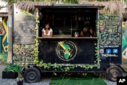 FILE - Deijha Gordon, 33, poses for a photograph in her food truck in Accra, Ghana, Dec. 11, 2024. Deijha, who relocated from New York, has obtained Ghanaian citizenship.