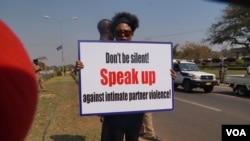 Protester Habiba Osman carries a placard denouncing violence against women during a march in Lilongwe, Malawi, Sept. 14, 2017. (L. Masina/VOA)