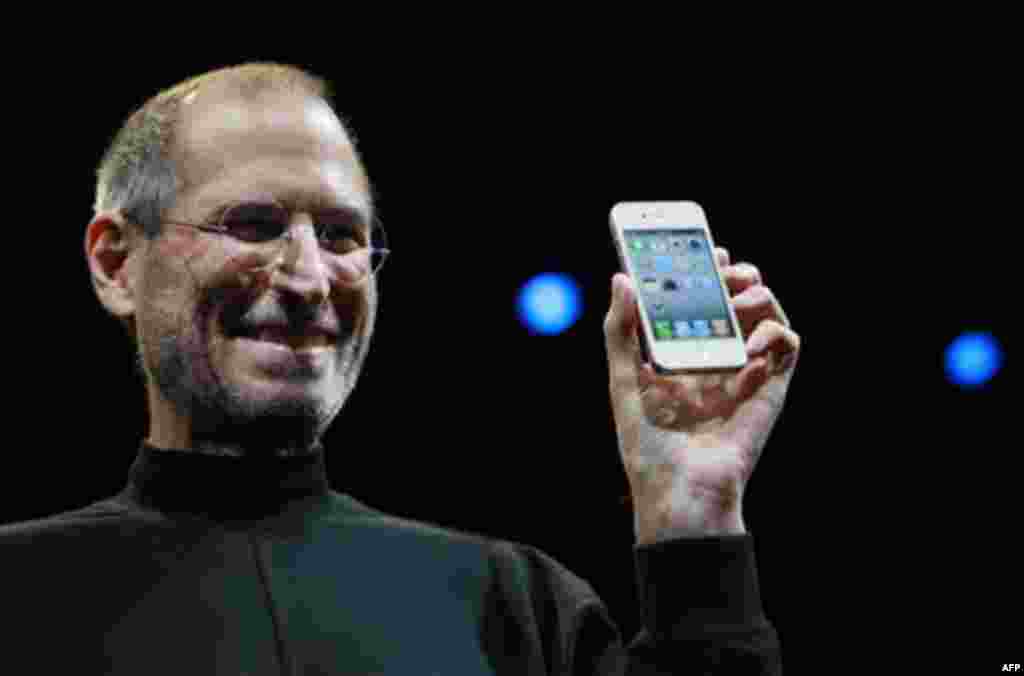 FILE - In this June 7, 2010, file photo, Apple CEO Steve Jobs smiles with a new iPhone at the Apple Worldwide Developers Conference in San Francisco. Apple on Wednesday, Oct. 5, 2011 said Jobs has died. He was 56. (AP Photo/Paul Sakuma, File)