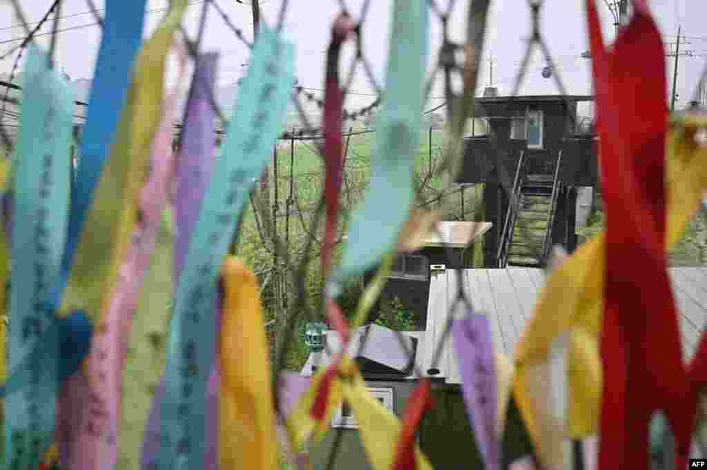 A South Korean guard post is seen through a military fence decorated with ribbons wishing for peace and reunification of the Korean Peninsula at Imjingak peace park in the border city of Paju.