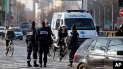 FILE - Police officers in Paris, France, Monday, March 23, 2015.