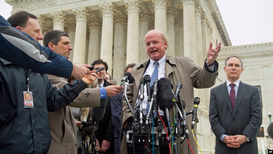 Michael Carvin, center, lead attorney for the petitioners, speaks to reporters outside the Supreme Court in Washington, March 4, 2015.