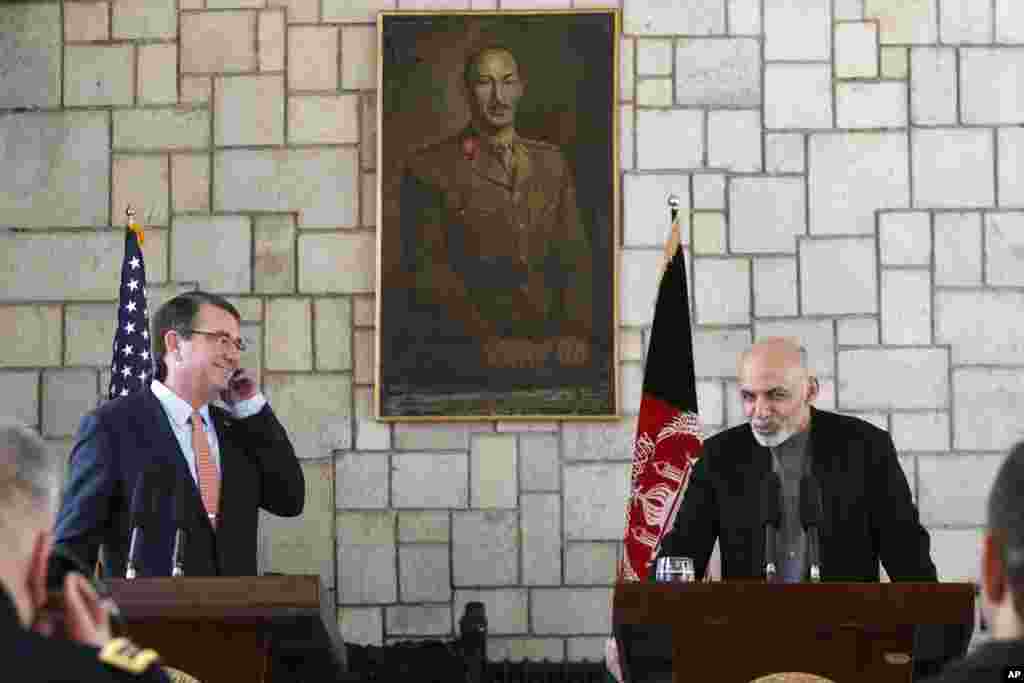 U.S. Defense Secretary Ashton Carter listens to remarks by Afghan President Ashraf Ghani during a news conference at the Presidential Palace in Kabul, Feb. 21, 2015.