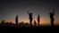 FILE - Women exercise in front of a trainer (L) as the sun sets near Kensington Oval in Bridgetown, Barbados, March 13, 2014. 