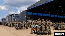 Members of the South Africa National Defence Force (SANDF) carry the mortal remains of 13 members that were killed in Central African Republic (CAR) during the handing over to the respective families at the Waterkloof Air Force Base, in Pretoria, March 28