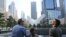 Visitors to the National September 11 Memorial take in the view from the north pool, Saturday, Sept. 10, 2016, in New York. Sunday marks the 15th anniversary of the attacks on the World Trade Center. (AP Photo/Mary Altaffer)