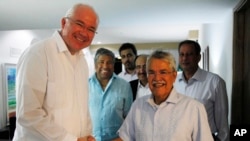 FILE - Saudi Arabia's Oil Minister Ali al-Naimi (r) shakes hands with Venezuela's Foreign Minister Rafael Ramirez, during a climate conference on Margarita Island, Venezuela, Nov. 5, 2014.