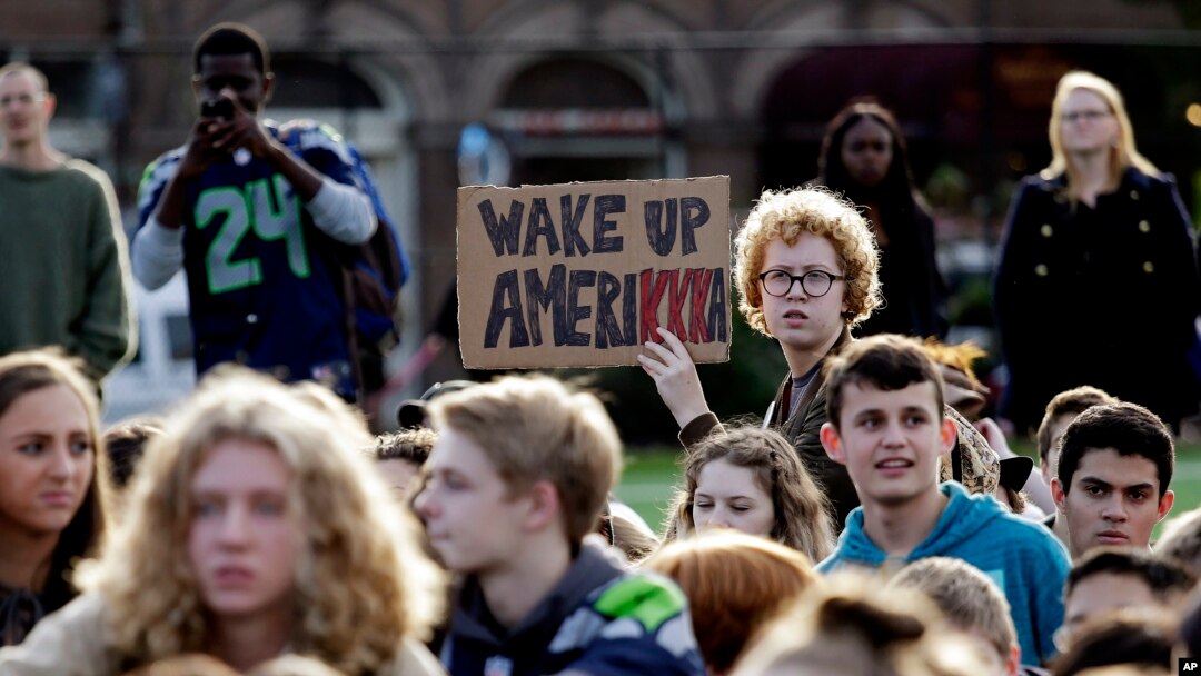 Students look on during a walkout from classes to protest the election of Donald Trump as president, Nov. 14, 2016, in Seattle, Washington. 