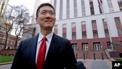 Hawaii Attorney General Doug Chin speaks with reporters in front of a federal courthouse after appearing there Dec. 6, 2017, in Seattle.