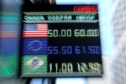 An electronic board shows currency exchange rates in Buenos Aires' financial district, Argentina, Aug. 12, 2019.